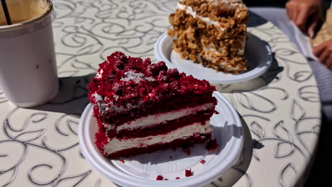 Delicious-cakes-and-coffee-on-table-in-outdoors-cafe,-motion-view