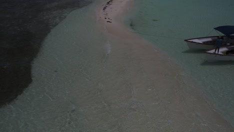 Drone-footage-of-waves-gently-washing-over-a-sandy-beach-at-Sardina-Island-in-Los-Roques