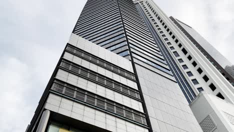 Close-up-tilt-up-shot-capturing-the-building-exterior-signage-of-major-malaysian-financial-banking-maybank-tower-at-downtown-civic-district-at-singapore