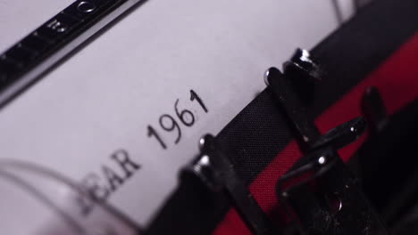 Year-1961,-Typing-on-White-Paper-in-Vintage-Typewriter,-Close-Up