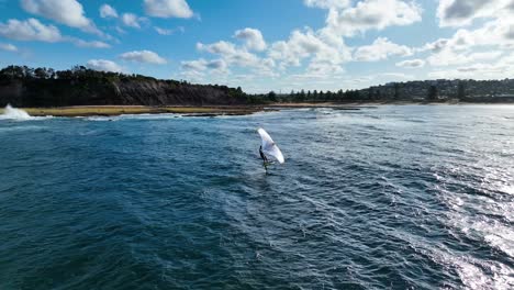 Aerial-Footage-Of-Man-Wing-Foiling-Or-Hydro-foiling-In-The-South-Pacific-Ocean,-Sydney,-Australia