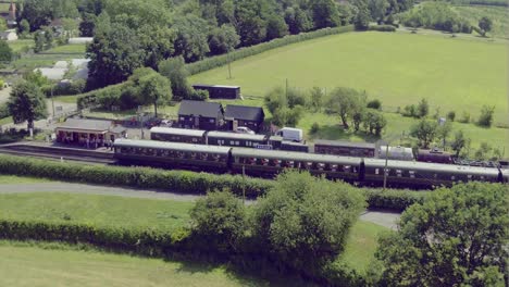 Aerial-pullback-of-a-steam-strain-in-Bodiam-station-revealing-the-East-Sussex-landscape