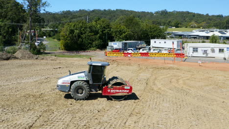 Aerial-Drone-Flyover-Padfoot-Roller-On-Dirt-Construction-Site,-4K