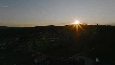 Aerial-descend-over-Swedish-village-in-sunset