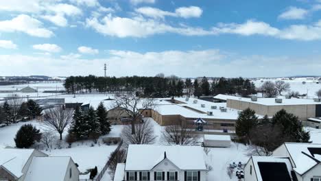 Snow-covered-home-with-parking-cars-during-snowy-winter-day