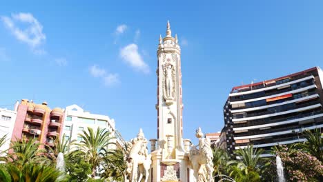 Tilt-up-shot-over-the-central-fountain-in-Luceros-square,-Alicante,-on-a-bright-summer-day