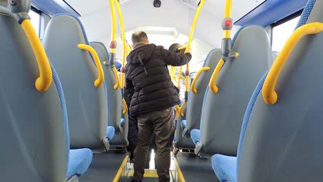 Back-view-of-bus-people-are-getting-off-the-bus-and-people-commuting-to-work---Handheld-Steady-Shot