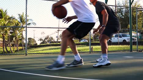 Two-men-playing-1v1-basketball-on-an-Outdoor-basketball-court-in-Hawaii