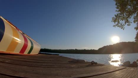 Caucasian-Man-Water-Skis-on-Blue-Lake-in-Summer-Sunset-Light,-FPV-Drone-Aerial-Reveal-and-Track