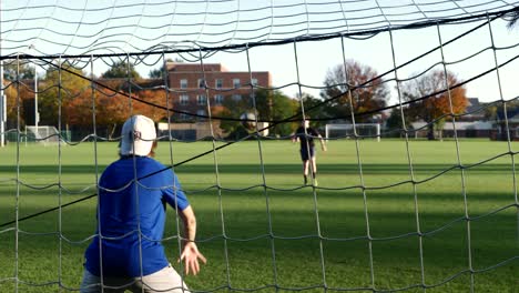 Two-college-guys-playing-soccer-during-autumn-in-slow-motion