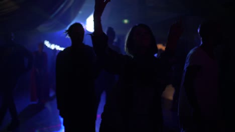 Silhouette-of-Person-Dancing-in-Dark-Room-with-Strobe-Light