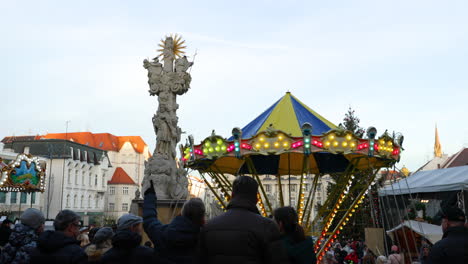 A-dominant-feature-of-the-Christmas-markets-in-Brno-in-the-form-of-a-children's-carousel-and-people-flowing-in-the-crowd-around-refreshment-stalls-at-Zeleny-market-captured-at-4k-60fps-slow-motion