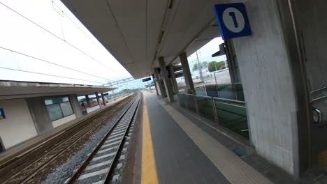 A-Train-Passes-By-An-Empty-Rimini-Train-Station-On-A-Cloudy-Day