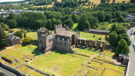 Aerial-View-Of-The-Ruins-Of-Melrose-Abbey-In-The-Borders-Area-Of-Scotland