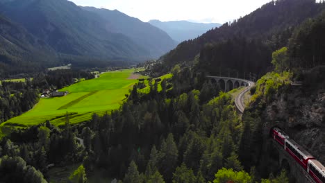 Aerial:-red-train-on-the-Landwasser-viaduct