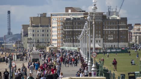 Time-lapse-of-crowds-of-people-on-beach-promenade-in-Brighton-UK-,-zoom-out