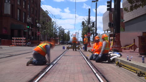 Time-lapse-video-of-construction-workers-lining-up-new-railroad-tracks-in-a-city