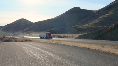 Semi-tractor-towing-a-white-trailer-full-of-product-across-southwest-Texas