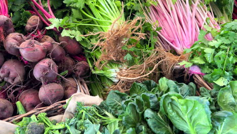 Fresh-organic-beetroot-and-green-herbs-for-sale-at-a-local-farmers-market-in-Marbella-Spain,-healthy-bio-vegetables,-4K-shot