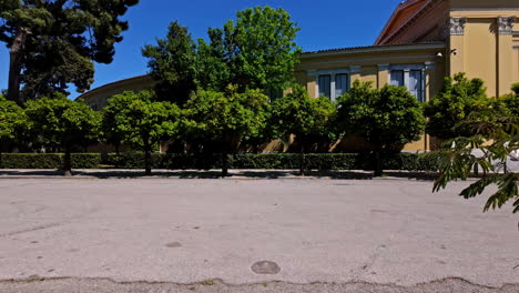 Athens,-Attica,-Greece--Pan-shot-of-outside-wall-of-iconic-Zappeion-hall,-Athens-historic-center,-Attica,-Greece-on-a-sunny-day