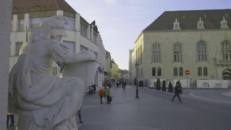 Szentháromság-street-Matthias-Church-Square-in-Buda-Castle-shot-with-turists-passing-by