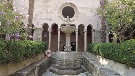 Approaching-a-fountain-belonging-to-the-Franciscan-Church-and-Monastery,-significant-religious-sites-in-Dubrovnik