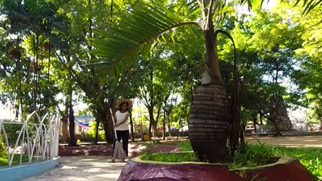 A-streetsweeper-attends-to-her-chores-at-the-church-premises-in-a-Mandaue-City-suburb,-Philippines