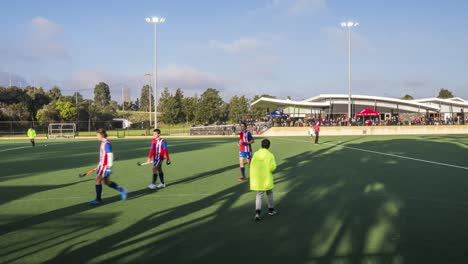 Panning-timelapse-from-left-to-right-of-men's-premier-league-field-hockey-match-in-front-of-a-crowd-at-KBH-Brumbies-club-rooms-at-Elgar-Park