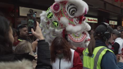 chinese-dragon-dancer-during-performance-celebration-new-years-in-china-town-london-2020-before-coronavirus-outbreak-lockdown-in-middle-of-crowd