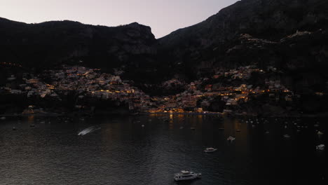 Panoramic-drone-shot-of-Positano-in-Amalfi-coast,-Italy-during-dusk