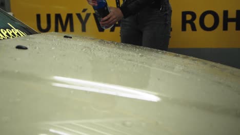 Car-shampoo-spraying-on-a-bmw-coupe-bonnet