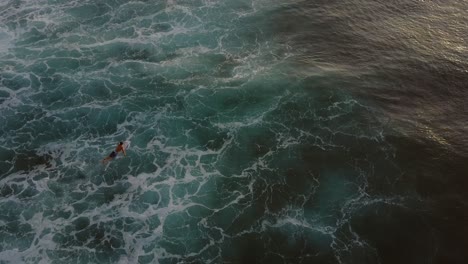 Surfer-during-sunset-at-the-famous-surf-spot-Uluwati-in-Bali