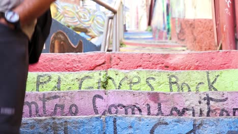 Man-walks-down-colorful-steps-at-VALPARAISO,-CHILE