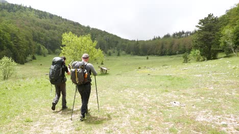 Two-people-hiking-alone-along-the-trail-in-the-mountains-on-a-sunny-day-in-Croatia