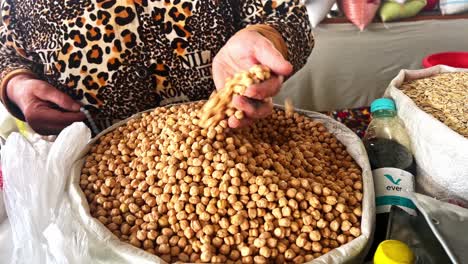 Macro-close-up-shot-of-raw-light-chickpeas-in-woman