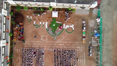 Aerial-View-of-school-children-Flag-hosting-at-Indian-school-during-Indian-Independence-day,-August-15