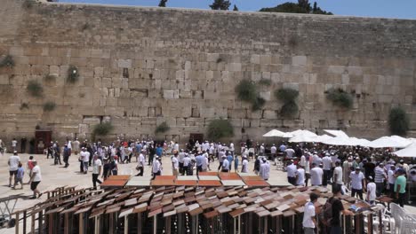 Dolly-shot-of-people-praying-by-Wailing-Wall,-Jerusalem,-Israel