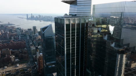 Drone-shot-towards-the-55-Hudson-Yards-skyscrapers-in-sunny-New-York,-USA