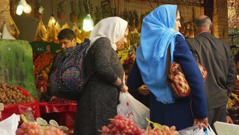 Three-Iranian-Women-Gathered-around-Mobile-Phone-in-Tajrish-Bazaar-in-Tehran,-Iran