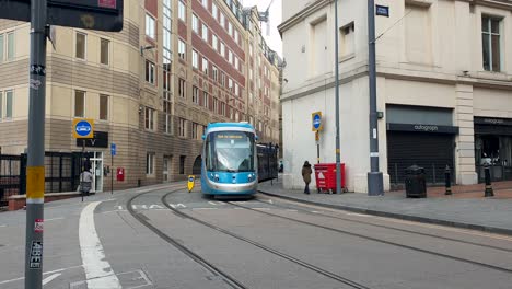 Close-up-of-the-West-Midlands-Metro-light-rail-tram-system-traveling-in-city-centre-of-county-of-West-Midlands,-Birmingham,-England-UK