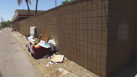 Dolly-past-assorted-trash-in-a-city-alleyway,-Sunnyslope,-Phoenix,-Arizona