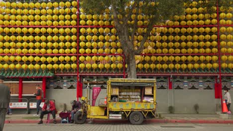 Three-wheeler-mobile-library-outside-Longshan-temple-in-Taipei-City,-Taiwan