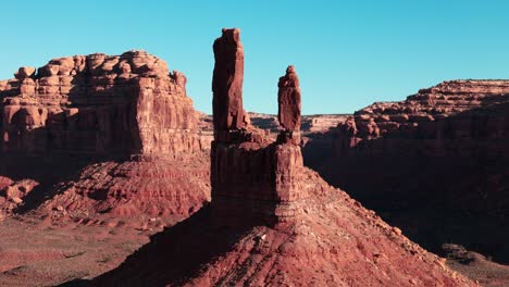 Wide-aerial-drone-orbit-establishing-shot-of-elephant-ears-rocks-in-beautiful-magic-light-at-Valley-of-the-Gods-in-Utah