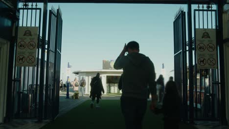 Father-and-Daugther-entering-seaside-pier-while-holding-hands