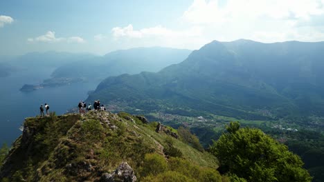 People-admiring-panorama-on-Grona-mount-top-with-Como-lake-in-background,-Italy