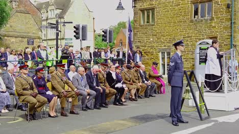 Military-officers,-dignitaries-and-the-general-public-listening-to-the-vicar-leading-the-commemorations-to-the-80th-anniversary-of-D-Day