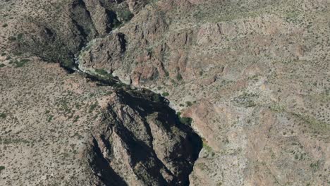 Aerial-Shot-of-Rugged-Rocky-Canyon-and-Arid-Desert-Terrain-in-Amaicha-del-Valle,-Tucumán