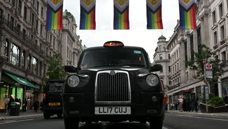 Black-Taxi-within-Regents-Street-with-it-being-Pride-Month,-London,-United-Kingdom