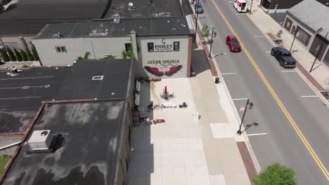 Cedar-Springs,-Michigan-sign-with-drone-video-pulling-out-to-reveal-downtown-area