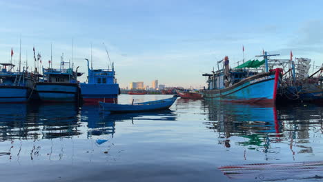 Da-Nang-tourist-destination-in-Vietnam-view-of-fisherman-traditional-wooden-boat-with-city-skyline